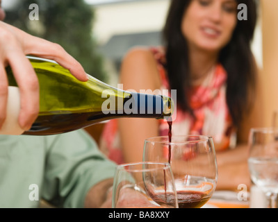 Waiter pouring wine in restaurant Stock Photo