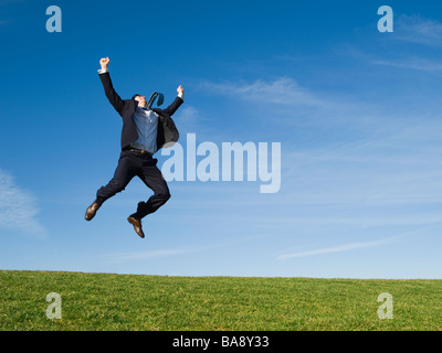 Businessman jumping in air Stock Photo