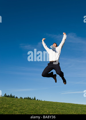 Businessman jumping in air Stock Photo