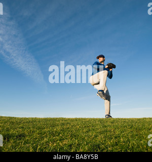 Baseball player throwing ball Stock Photo