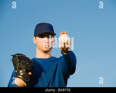 Baseball player holding ball Stock Photo