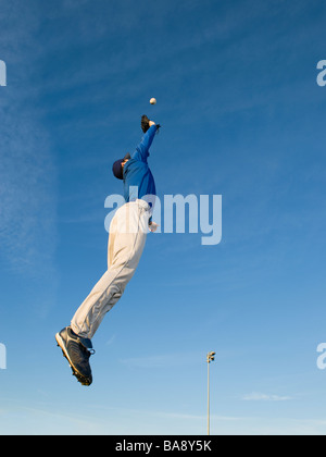 Baseball player catching ball Stock Photo