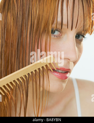 Woman combing hair Stock Photo