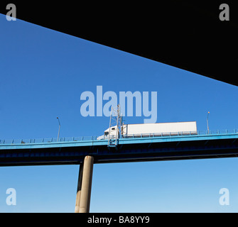 Truck on highway overpass Stock Photo