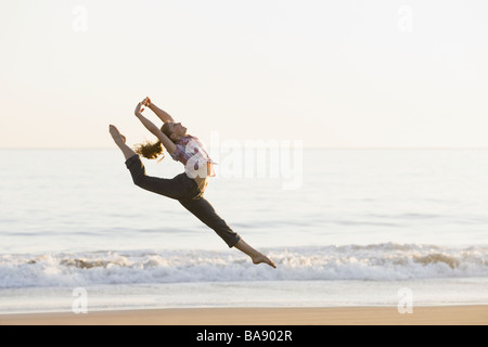 Woman dancing on beach Stock Photo