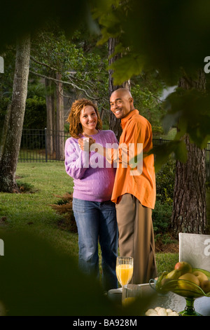 African-American couple dancing outdoors, woman pregnant Stock Photo