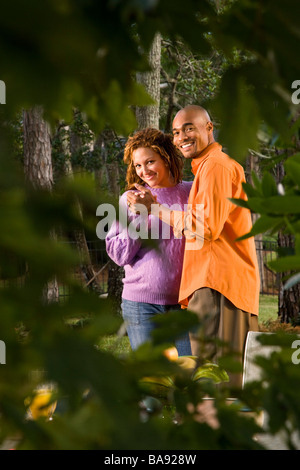 African-American couple dancing outdoors, woman pregnant Stock Photo