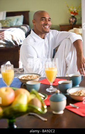 African-American man sitting at breakfast table Stock Photo