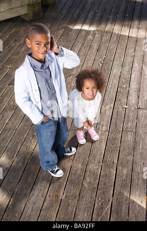 High angle view of African American children standing on boardwalk in park Stock Photo