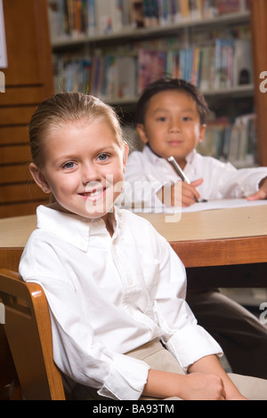 Portrait of school kids in library Stock Photo