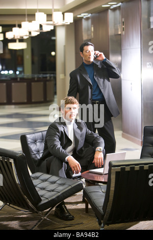 Portrait of multi-racial businessmen in modern lobby Stock Photo