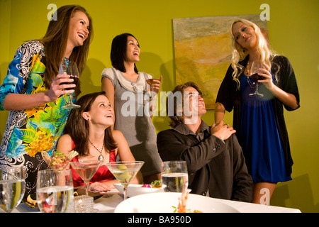 Group of stylish young adults in upscale restaurant having dinner Stock Photo