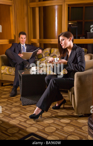 Businesspeople meeting in hotel lobby Stock Photo