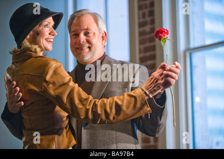Romantic middle-aged couple dancing in living room Stock Photo