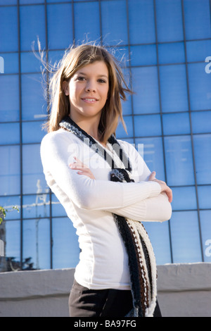 Young woman standing on rooftop of downtown condo in city Stock Photo