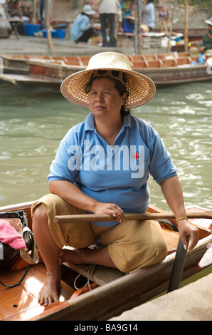 Portrait of a Thai woman in her boat at the Floating Market Damnoen Saduak near Bangkok Thailand Stock Photo