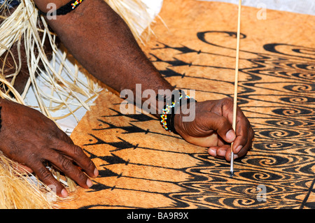 Bark painting, local artist paints traditional motifs on the bark of the Khambouw tree, Lake Sentani area, West Papua, Indonesia Stock Photo