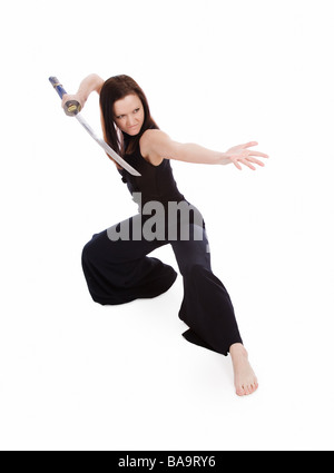 Beautiful woman in an aggressive posture with a sword on a white background Stock Photo