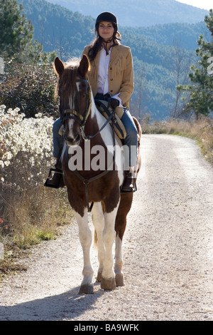 attractive young woman horseriding in spanish countryside Stock Photo