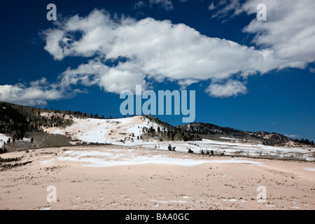 Winter snow is pink with wind blown sand and grit Highway 50 west of Gunnison Colorado near Curecanti National Recreation Area Stock Photo