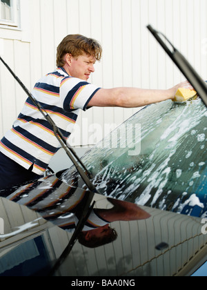 A man washing a car, Sweden. Stock Photo