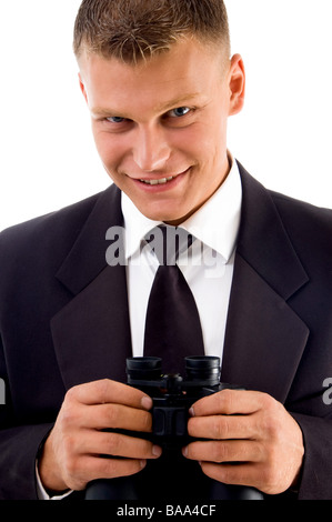 handsome young executive holding binoculars smiling Stock Photo