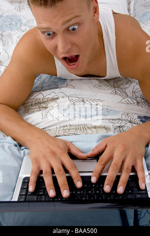 man surprised while working on laptop Stock Photo