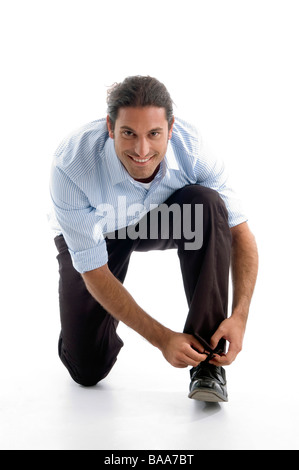 young good looking man tying his shoelace Stock Photo