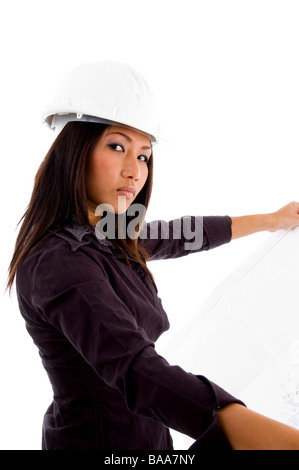 young constructor holding blue prints and looking at camera Stock Photo