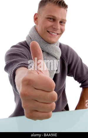 smiling young man showing thumbs up Stock Photo