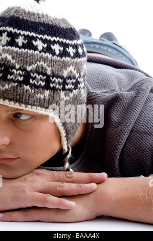 close view of laying young man wearing winter hat Stock Photo