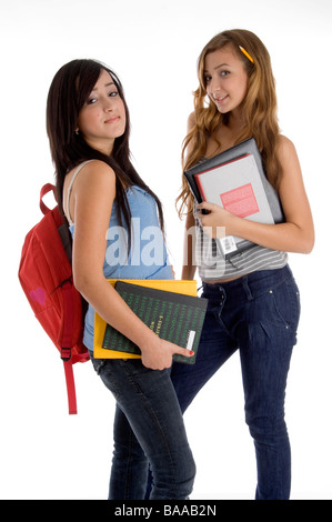 School Girl holding books standing at school Stock Photo - Alamy