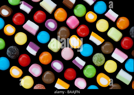 Multicoloured dolly mixtures and smarties sweets pattern on black Stock Photo