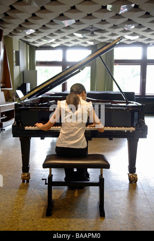 Young woman playing the piano, Duesseldorf, Germany Stock Photo