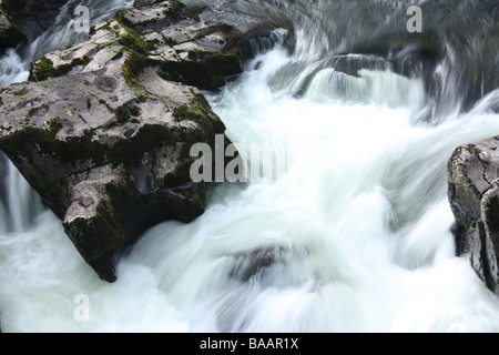 Moving milky water at Swallow Falls, Betws-Y-Coed, Snowdonia, Wales. Stock Photo