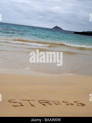 stressed at Punta Cormoran, Floreana Island, Galapagos Islands, Ecuador in September - word stress written in the sand beach, stress concept Stock Photo