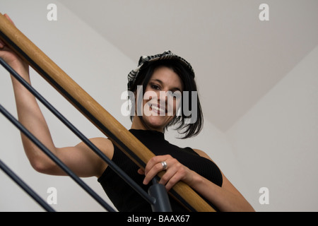 Women pose on the stairrail - Frau posiert am Treppengeländer Stock Photo
