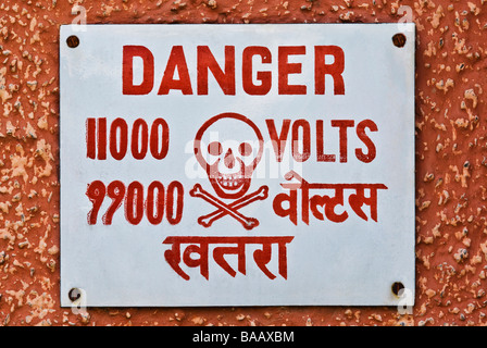 High Voltage warning signboard on a wall, Gurgaon, Haryana, India Stock Photo