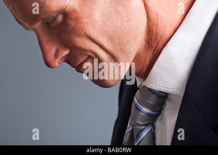 Portrait of businessman with head hung in shame Stock Photo