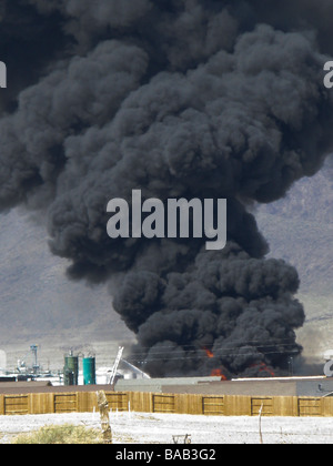 An industrial fire in Fernley Nevada consisting of plastic pipe with a snorkel truck fighting the fire Stock Photo
