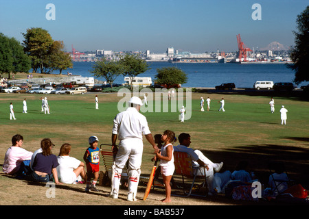 Cricket Team Players playing a Cricket Match on the Stanley Park Pitch Ground in Summer in Vancouver British Columbia Canada Stock Photo