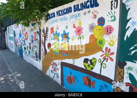 Spanish language mural for schools on wall surrounding Parque Papagayo in Acapulco, Mexico Stock Photo