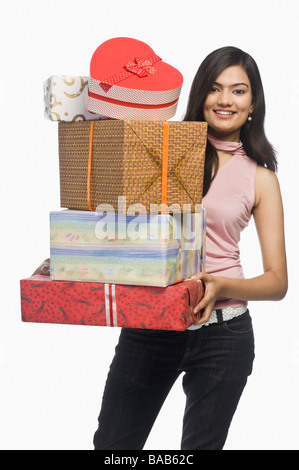 Woman holding gift boxes and smiling Stock Photo