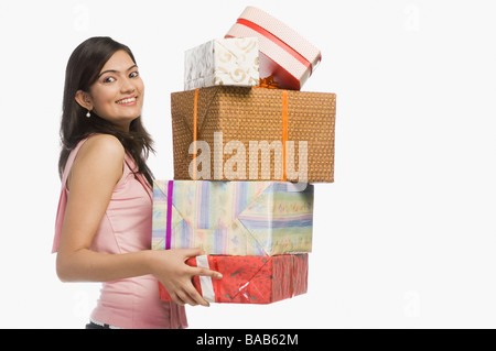 Woman holding gift boxes and smiling Stock Photo