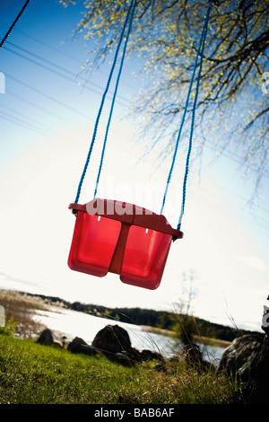 A red swing, Sweden Stock Photo - Alamy