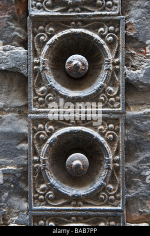 Decorative door bell pulls on in an alleyway in Siena, Tuscany, Italy. Stock Photo