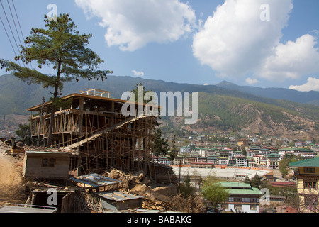 Rudimentary wooden scaffoldings on building in Thimphu capital city of Bhutan, sunny spring day, townscape. 91008 Bhutan-Thimphu Stock Photo