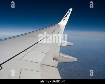 Starboard wing of a Boeing 737-800 aircraft in flight.  Operated by Ryan Air Stock Photo