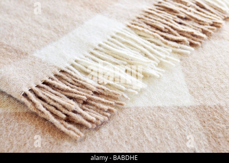 Soft and warm folded alpaca wool blanket with fringe Stock Photo