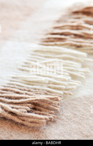 Soft and warm folded alpaca wool blanket with fringe Stock Photo